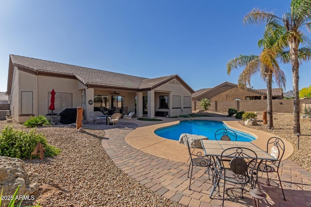 view of swimming pool featuring a fenced in pool, a fenced backyard, ceiling fan, and a patio area