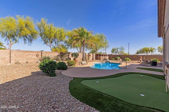 view of pool with a fenced backyard and a patio area