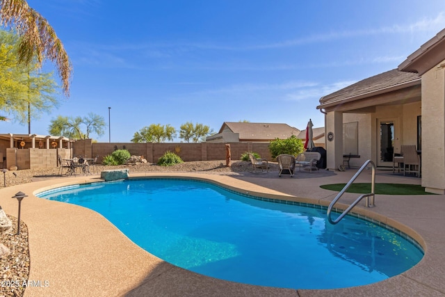 view of swimming pool featuring a fenced backyard, a fenced in pool, and a patio area