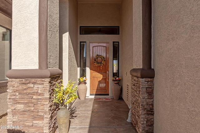 entrance to property with stucco siding and stone siding