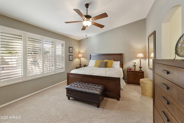 bedroom with ceiling fan, light colored carpet, and lofted ceiling