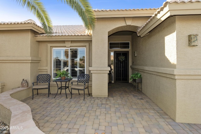 doorway to property with a patio