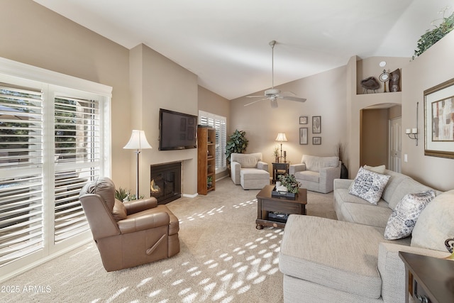 carpeted living room with vaulted ceiling and ceiling fan