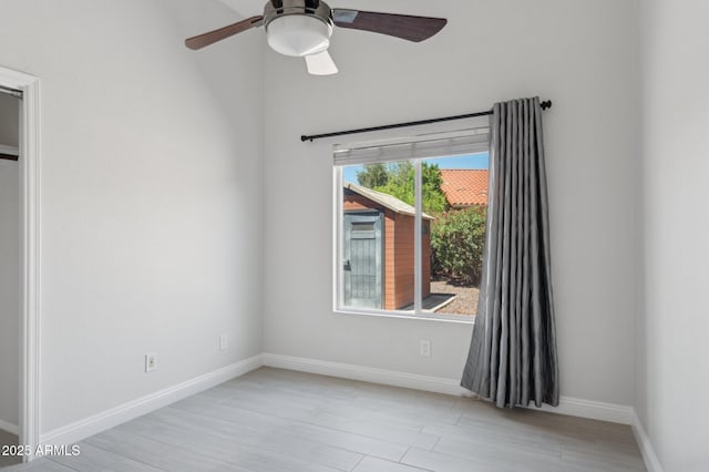 10450 E Terra Dr, Scottsdale, AZ 85258 - unfurnished room with light wood-type flooring, ceiling fan, and baseboards