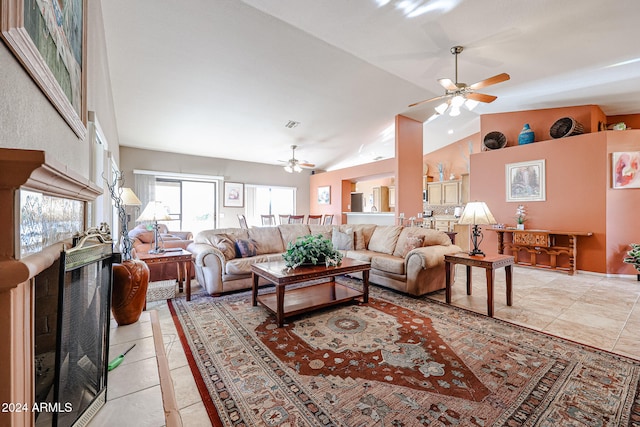 living room with ceiling fan, light tile patterned flooring, and vaulted ceiling