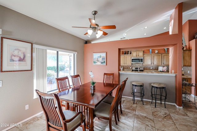 dining room featuring ceiling fan and vaulted ceiling