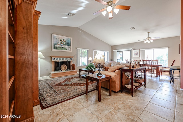 living room with ceiling fan, a wealth of natural light, and vaulted ceiling