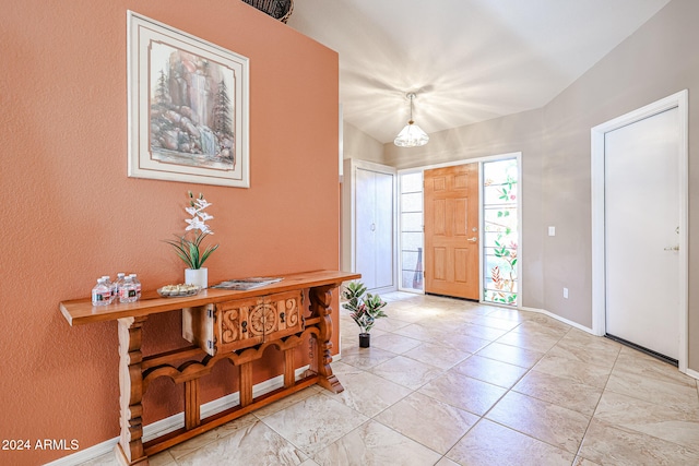 entrance foyer with lofted ceiling and a chandelier