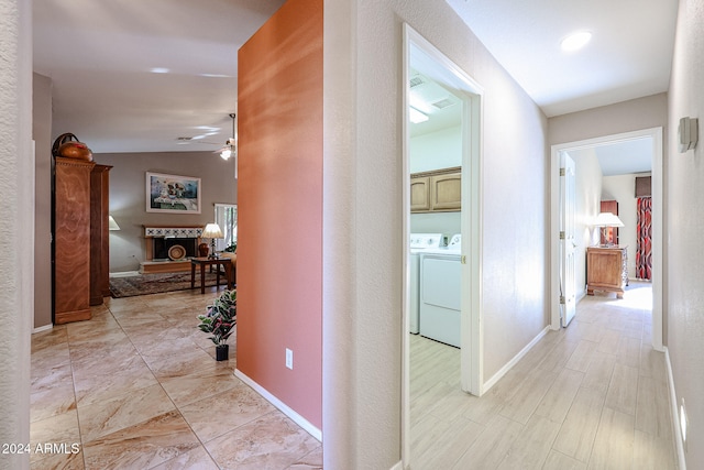 corridor featuring separate washer and dryer and lofted ceiling