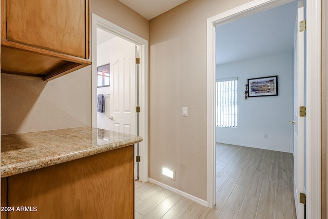 corridor with light hardwood / wood-style flooring