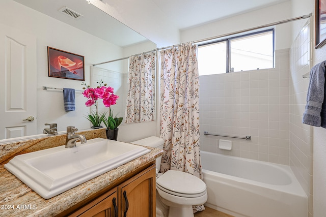 full bathroom with vanity, toilet, and shower / tub combo