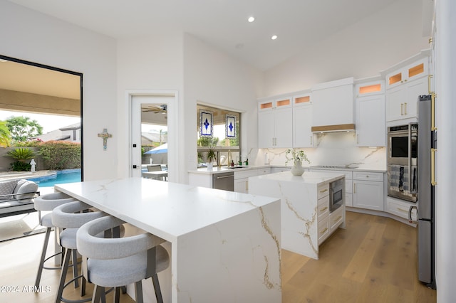 kitchen with white cabinets, a center island, and a wealth of natural light