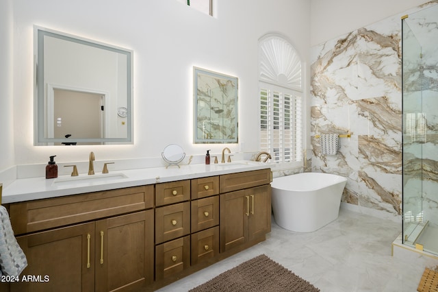 bathroom featuring a wealth of natural light, vanity, tile walls, and plus walk in shower