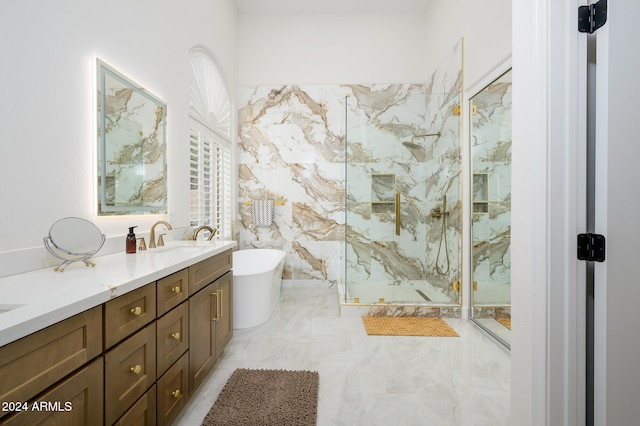 bathroom featuring shower with separate bathtub and vanity