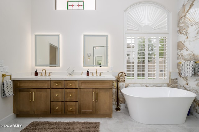 bathroom featuring a bathing tub, vanity, and tile walls