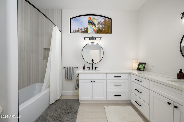 bathroom with hardwood / wood-style floors, vanity, and shower / bath combination with curtain