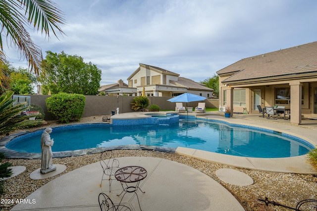 view of pool featuring an in ground hot tub and a patio