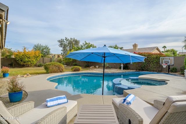 view of swimming pool featuring a patio area and an in ground hot tub