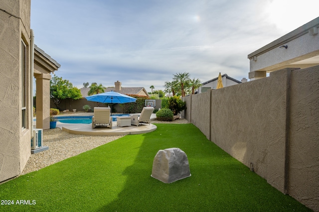 view of yard with a fenced in pool