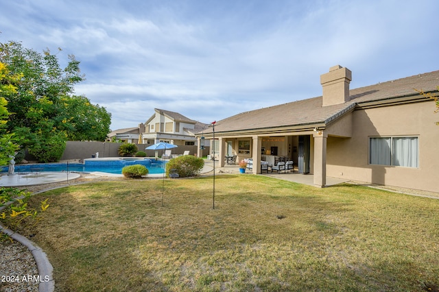 view of yard with a patio and a fenced in pool