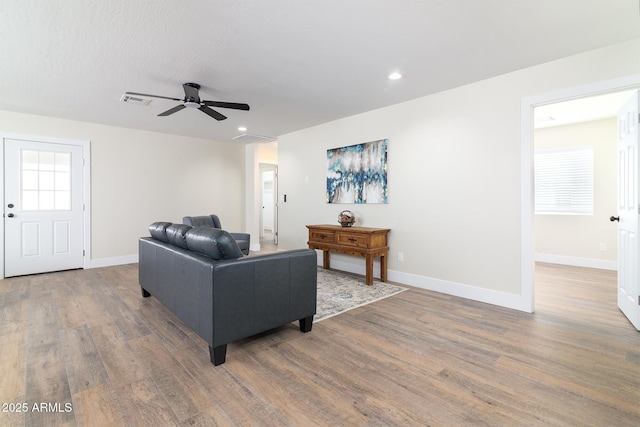 living room with ceiling fan, hardwood / wood-style floors, and a textured ceiling