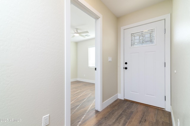 foyer with ceiling fan and dark hardwood / wood-style flooring