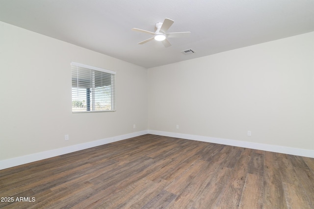 empty room featuring ceiling fan and dark hardwood / wood-style flooring