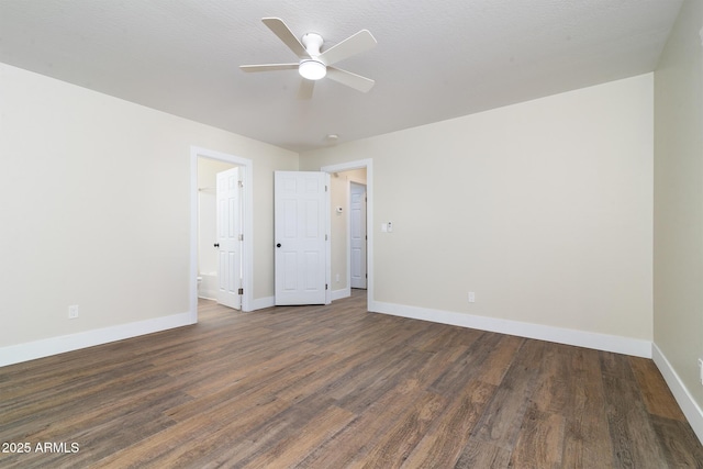 unfurnished room with ceiling fan and dark wood-type flooring