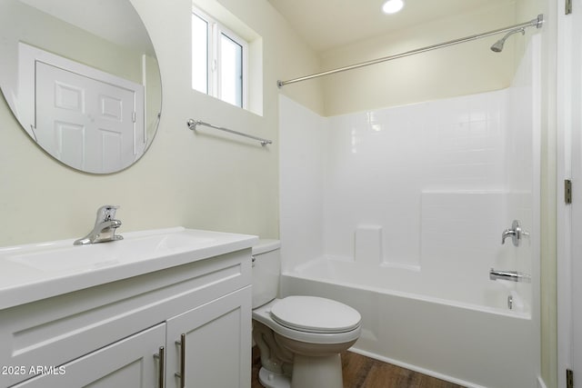 full bathroom featuring bathing tub / shower combination, hardwood / wood-style floors, vanity, and toilet