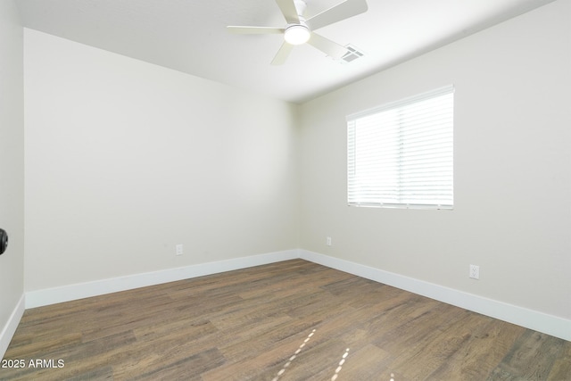 empty room featuring dark hardwood / wood-style floors and ceiling fan