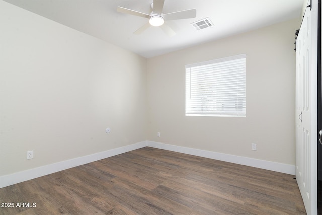 unfurnished room featuring ceiling fan and dark wood-type flooring