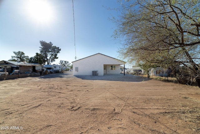 rear view of house featuring central AC unit