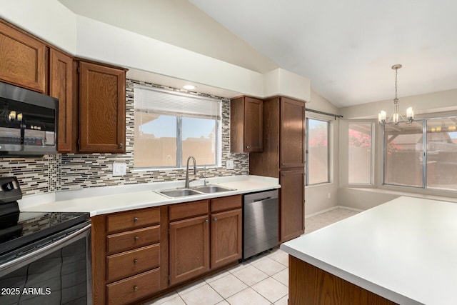 6317 E Colby St, Mesa, AZ 85205 - kitchen with appliances with stainless steel finishes, lofted ceiling, a sink, decorative backsplash, and light countertops