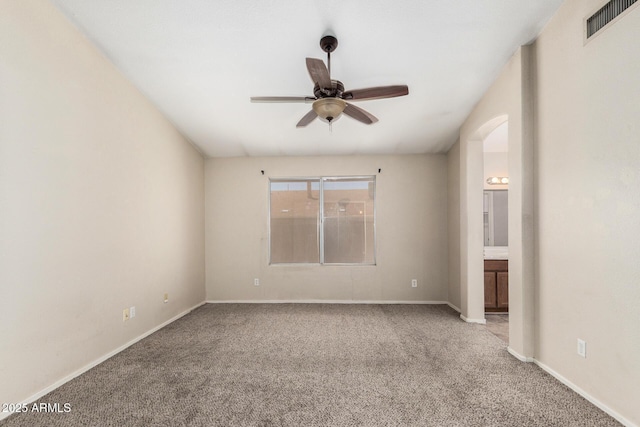 6317 E Colby St, Mesa, AZ 85205 - carpeted spare room featuring a ceiling fan, baseboards, and arched walkways