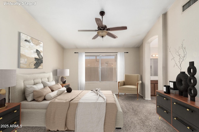 6317 E Colby St, Mesa, AZ 85205 - bedroom with arched walkways, connected bathroom, light carpet, and a ceiling fan
