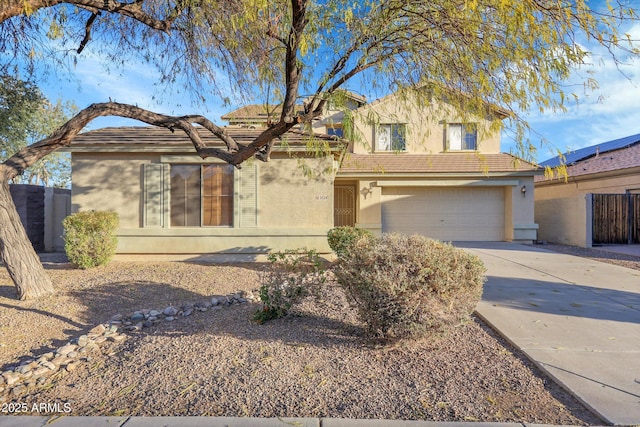 view of front facade with fence, a garage, driveway, and stucco siding