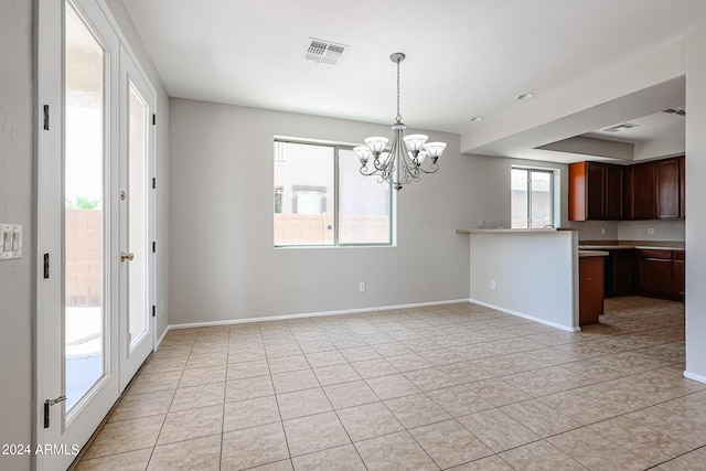 kitchen featuring hanging light fixtures, an inviting chandelier, baseboards, and visible vents