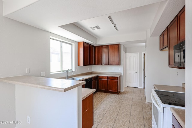 kitchen featuring light countertops, visible vents, a sink, a peninsula, and black appliances