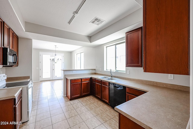 kitchen featuring visible vents, light tile patterned flooring, a sink, a peninsula, and black appliances