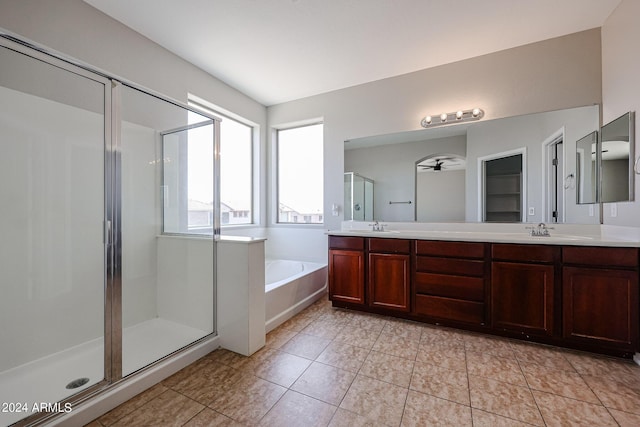 bathroom with double vanity, a stall shower, a sink, and a bath