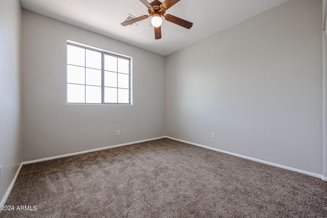 empty room featuring carpet floors, baseboards, and a ceiling fan