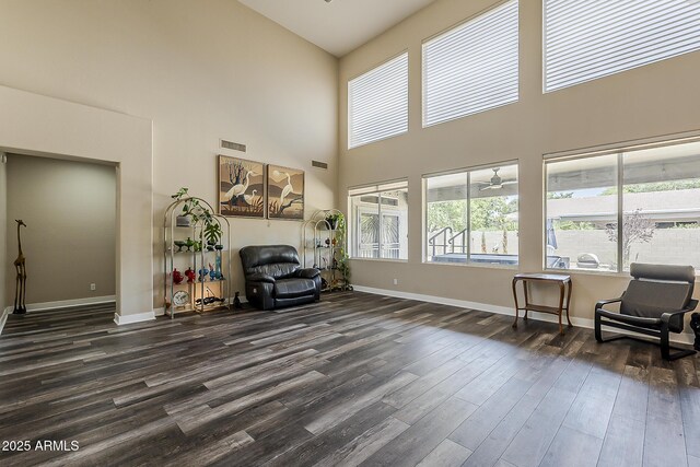 3062 E Cullumber St, Gilbert, AZ 85234 - sitting room featuring dark wood-style floors, a towering ceiling, and ceiling fan