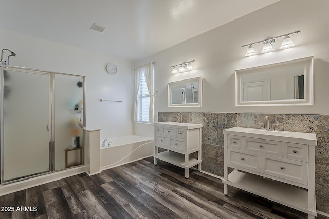 3062 E Cullumber St, Gilbert, AZ 85234 - bathroom with a shower stall, a bath, tile walls, two vanities, and wood finished floors