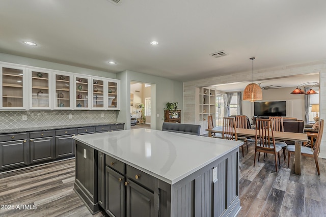3062 E Cullumber St, Gilbert, AZ 85234 - kitchen with open floor plan, dark wood-type flooring, backsplash, a kitchen island, and recessed lighting