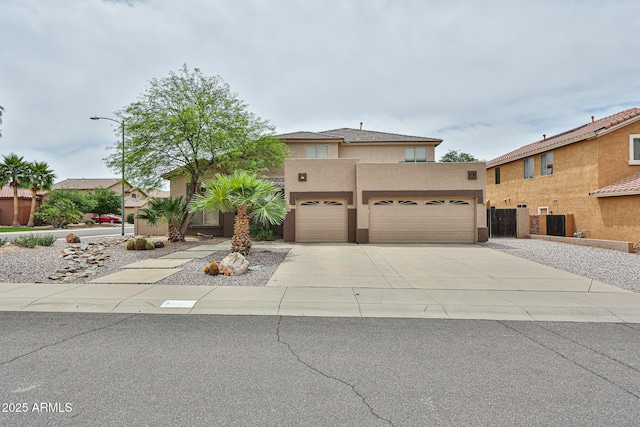 view of front of property featuring driveway, stucco siding, a garage, and central air condition unit