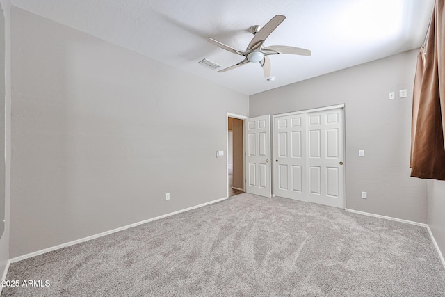 unfurnished bedroom featuring carpet floors, baseboards, a closet, and ceiling fan