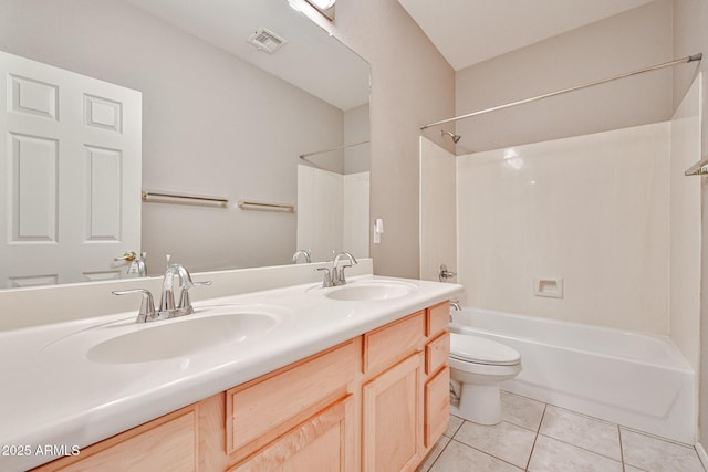 bathroom with tile patterned floors, bathing tub / shower combination, toilet, and double vanity
