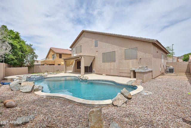 view of swimming pool featuring a fenced backyard, a patio area, and a pool with connected hot tub