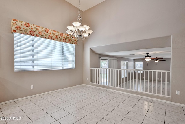 spare room with light tile patterned flooring, a chandelier, ceiling fan, high vaulted ceiling, and baseboards