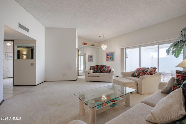 carpeted living room with a chandelier and a textured ceiling